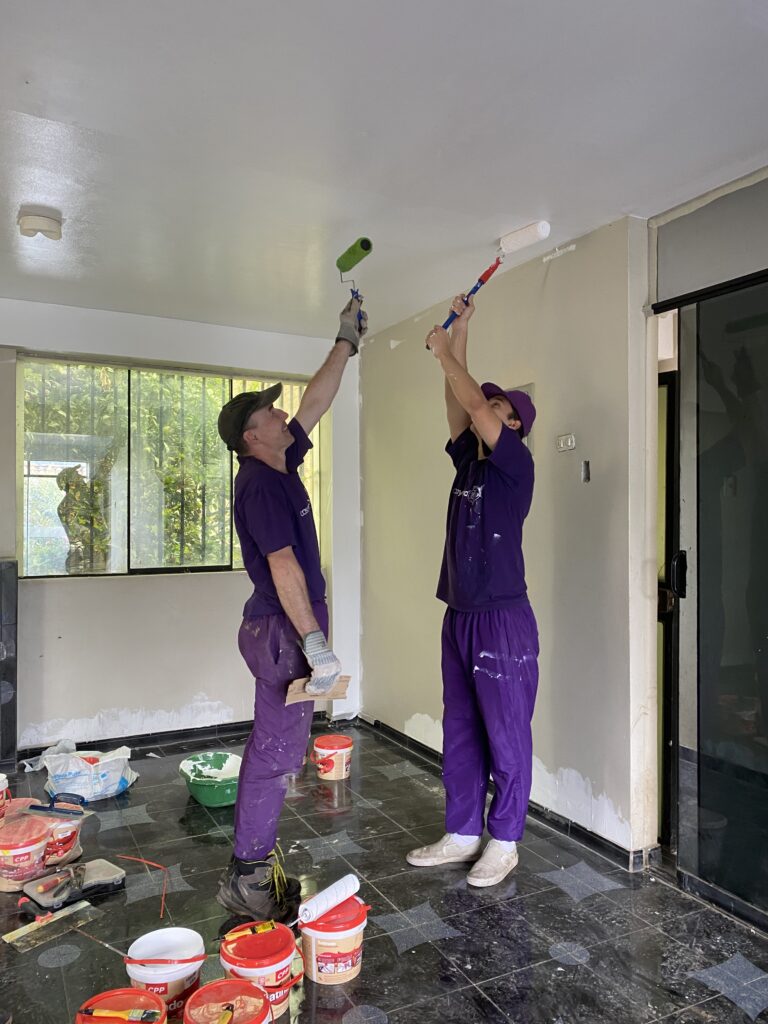 Amos and Albert paint the ceiling of casayohana's new apartment